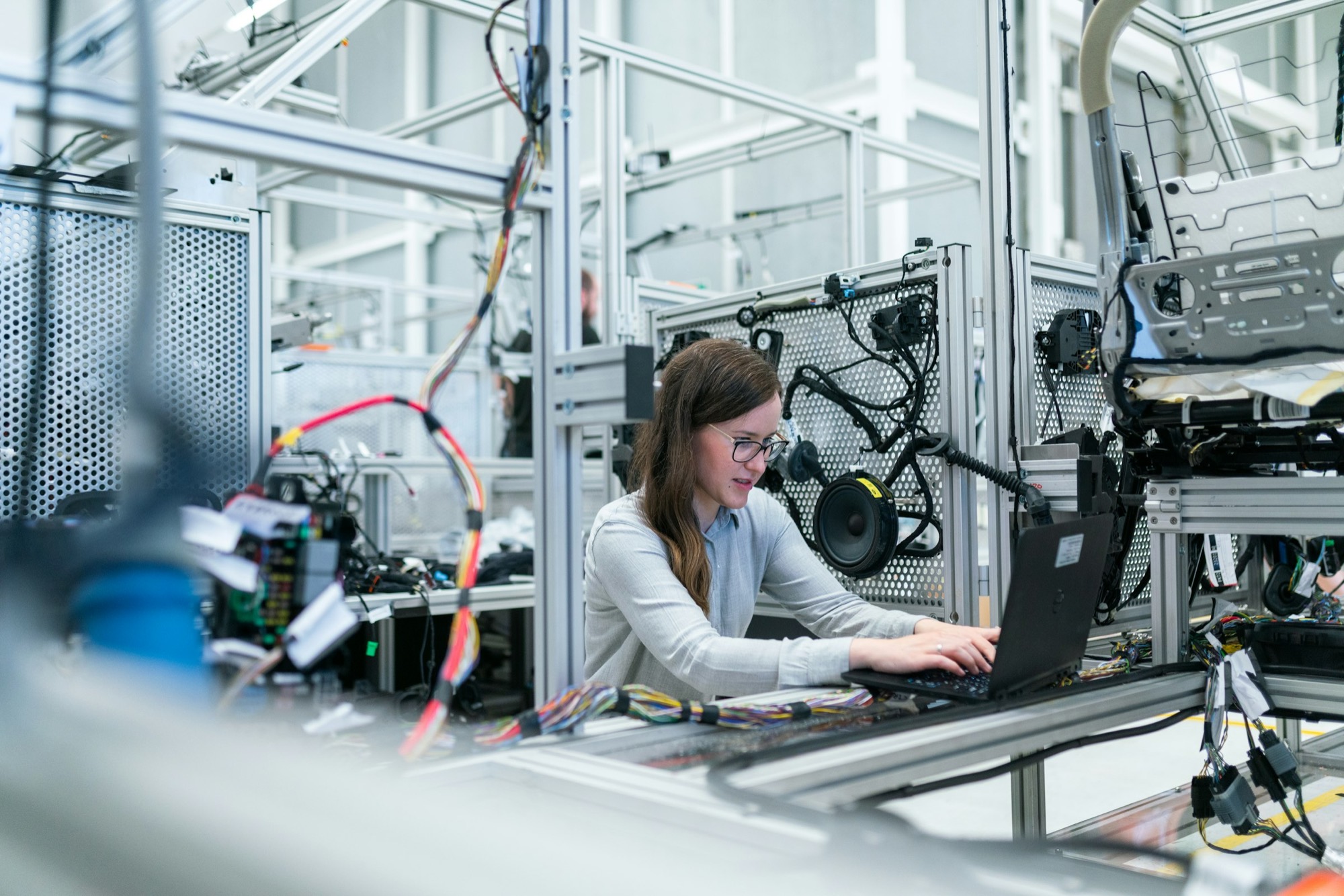 Engineer testing wiring and electronics on an industrial test rig
